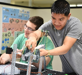 A PLTW student engaged in a hands on activity.